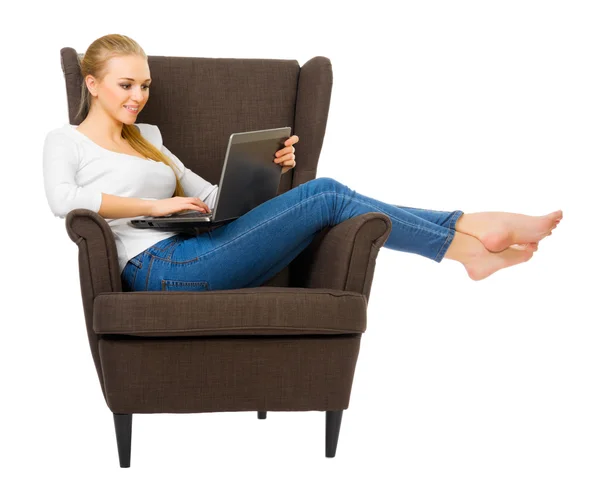 Young girl with laptop in chair — Stock Photo, Image