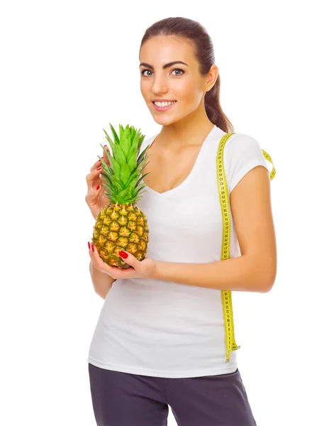 Young girl with pineapple and measurement tape — Stock Photo, Image