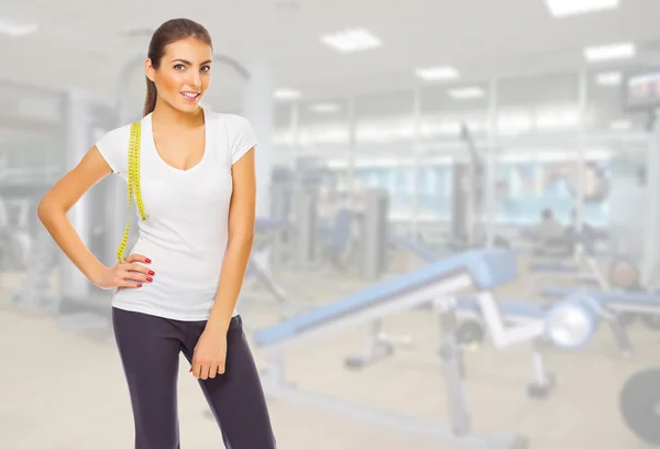 Girl with measurement tape at gym club — Stock Photo, Image