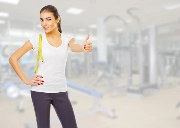 Young girl with measurement tape at gym club — Stock Photo, Image