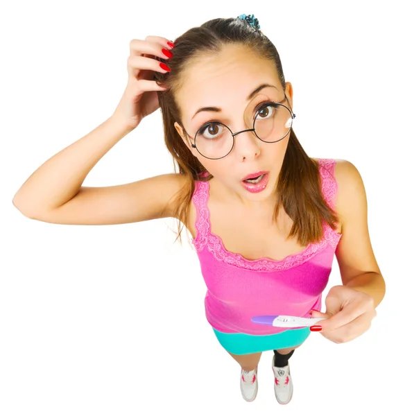 Funny schoolgirl in nerd glasses with positive pregnacy test — Stock Photo, Image