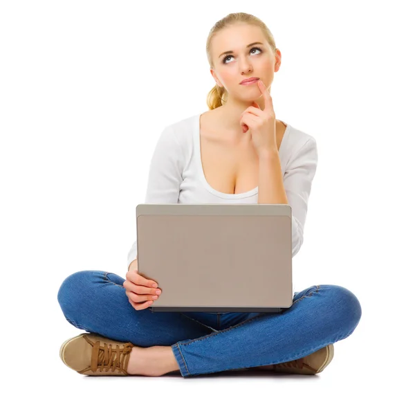 Young thinking woman with laptop — Stock Photo, Image