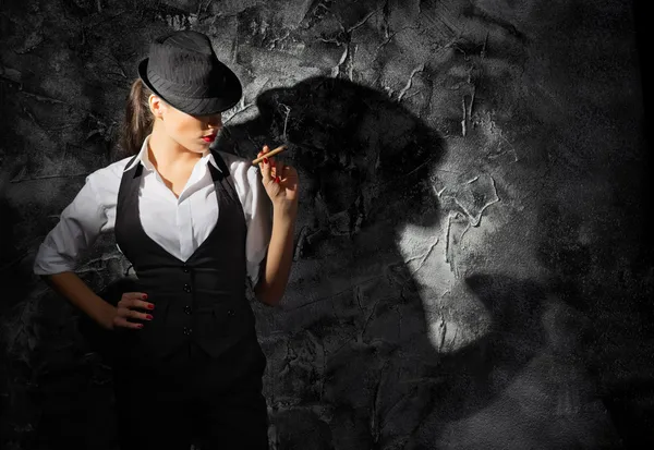 Young woman in hat with cigar — Stock Photo, Image