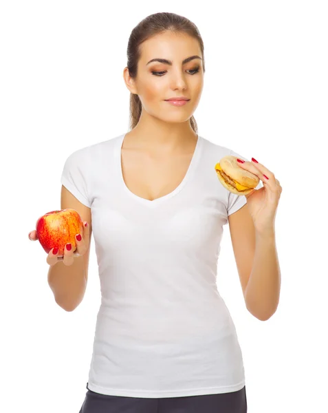 Mladá dívka s apple a hamburger — Stock fotografie