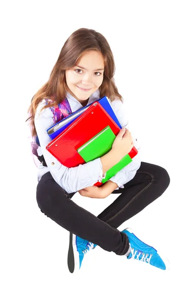 Miling chica sentada con mochila y libros sobre blanco — Foto de Stock