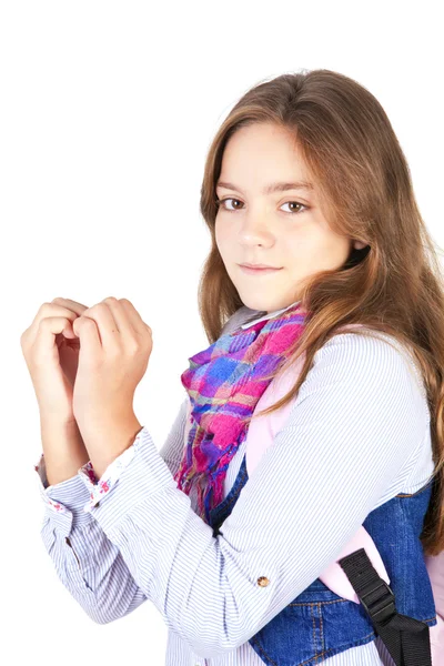 Girl with backpack showing heart by hands over white — Stock Photo, Image