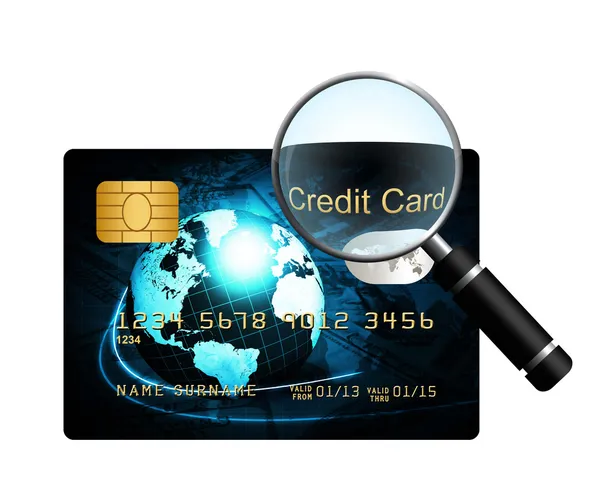 Creditcard met vergrootglas op witte achtergrond — Stockfoto