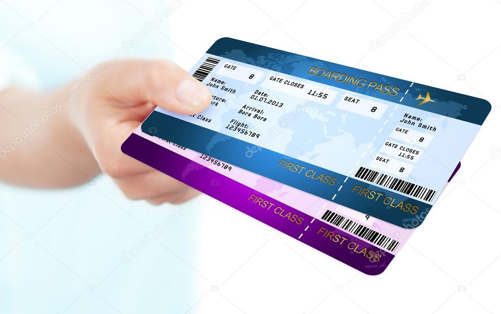 two boarding pass tickets holded by hand over white background