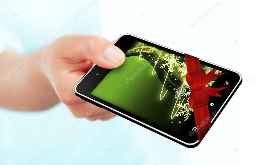 hand holding mobile phone with christmas screen over white backg