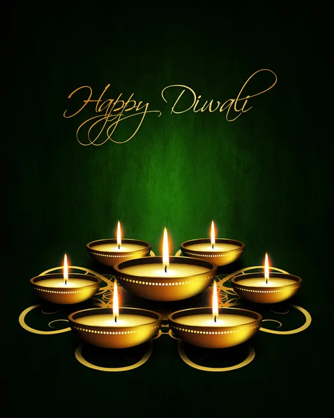 Oil lamp with diwali greetings over dark background — Stock Photo, Image