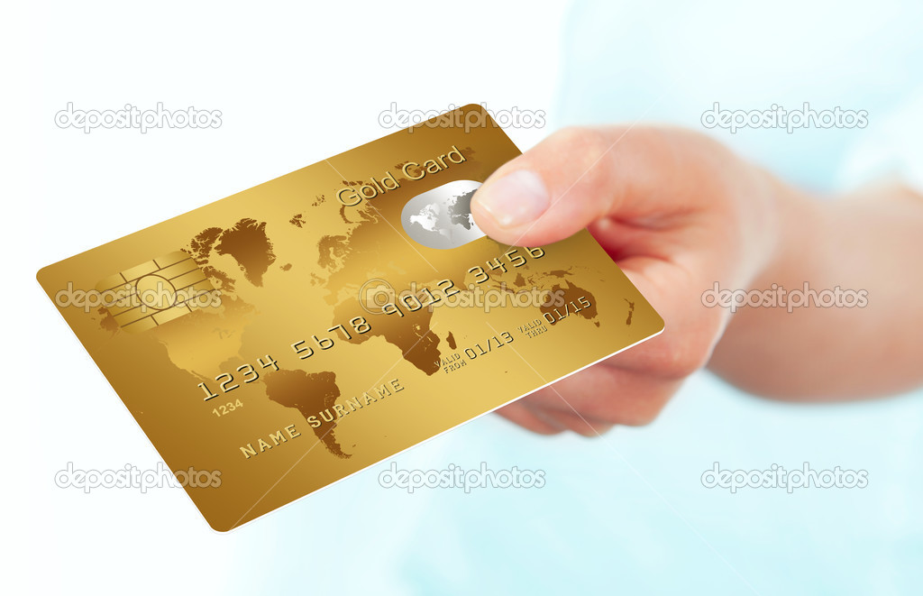 gold credit card holded by hand over white