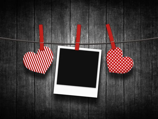 Hearts hanging on clothesline over wooden background — Stock Photo, Image