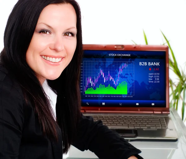 Smiling brunette businesswoman in office with laptop — Stock Photo, Image