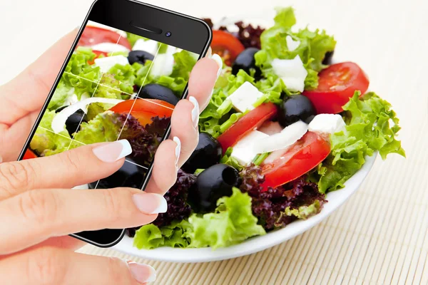 Hand making photo of salad by cellphone — Stock Photo, Image