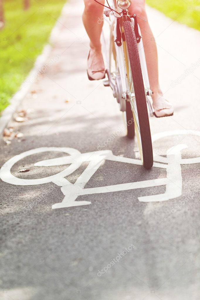 Blurred woman riding bicycle on a bike path