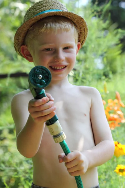 Boy watering — Stock Photo, Image