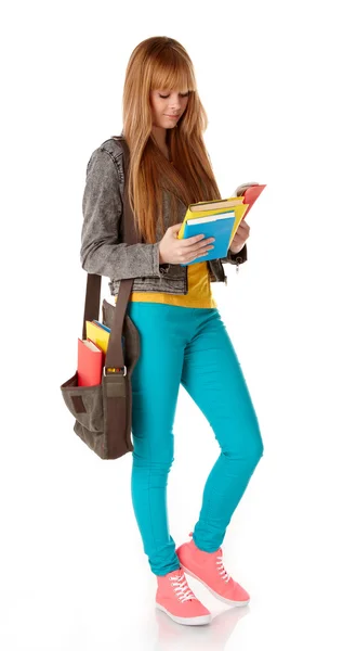 Portret van schattig meisje met een leerboek in handen op zoek geïsoleerd op witte achtergrond — Stockfoto