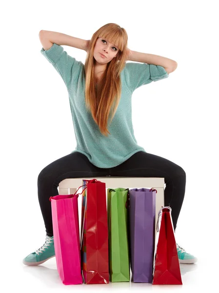 Young girl with shopping bags in shop — Stock Photo, Image