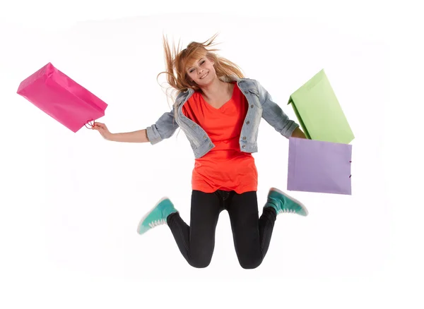 Young girl with shopping bags in shop — Stock Photo, Image