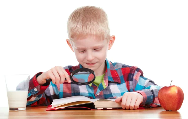 Child looking through a magnifying glass — Stock Photo, Image