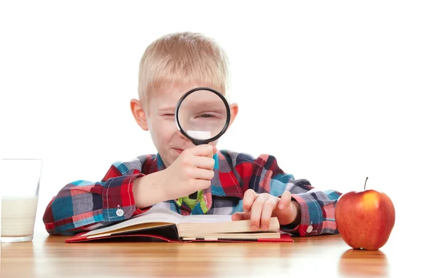 Child looking through a magnifying glass — Stock Photo, Image