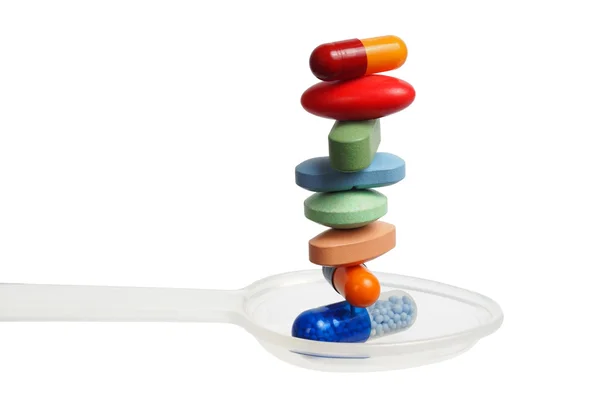 Stack of pills on a spoon — Stock Photo, Image