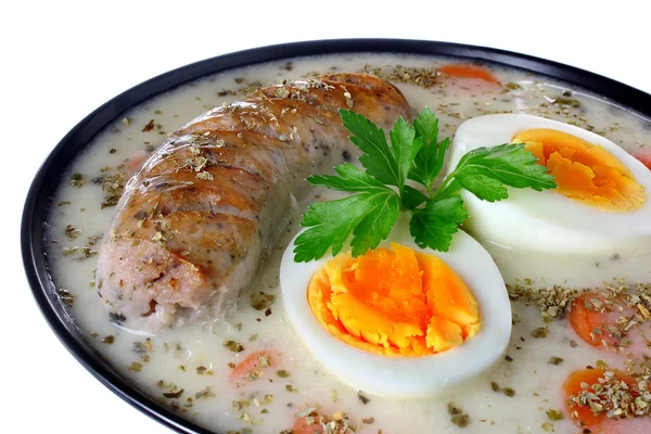 Delicious sour soup with egg and sausage — Stock Photo, Image