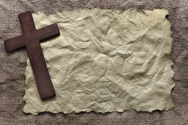 Wooden cross on old paper — Stock Photo, Image