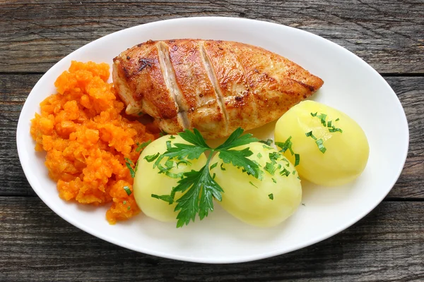 Stekt kycklingfilé med potatis och morötter — Stockfoto