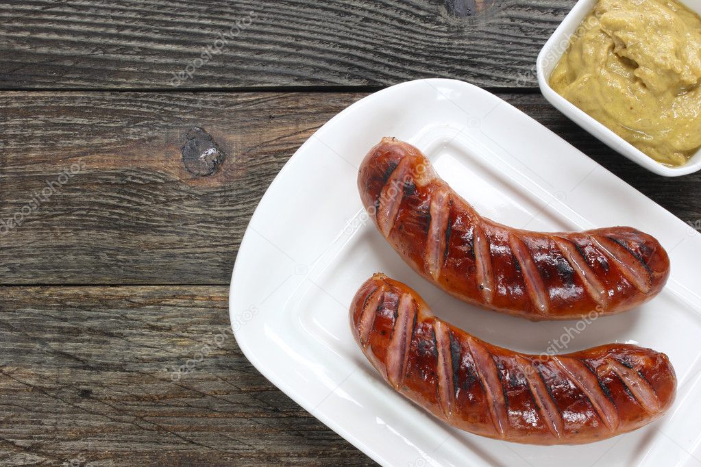 Grilled sausages on white plate