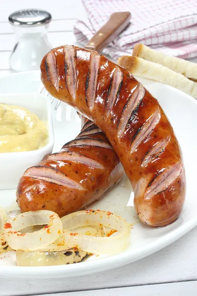 Delicious fried sausage on plate — Stock Photo, Image