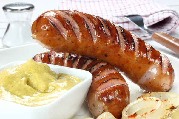 Delicious fried sausage on plate — Stock Photo, Image