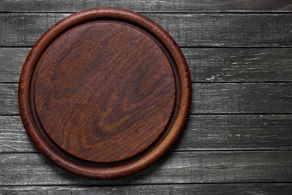 Empty old cutting board on wooden table — Stock Photo, Image