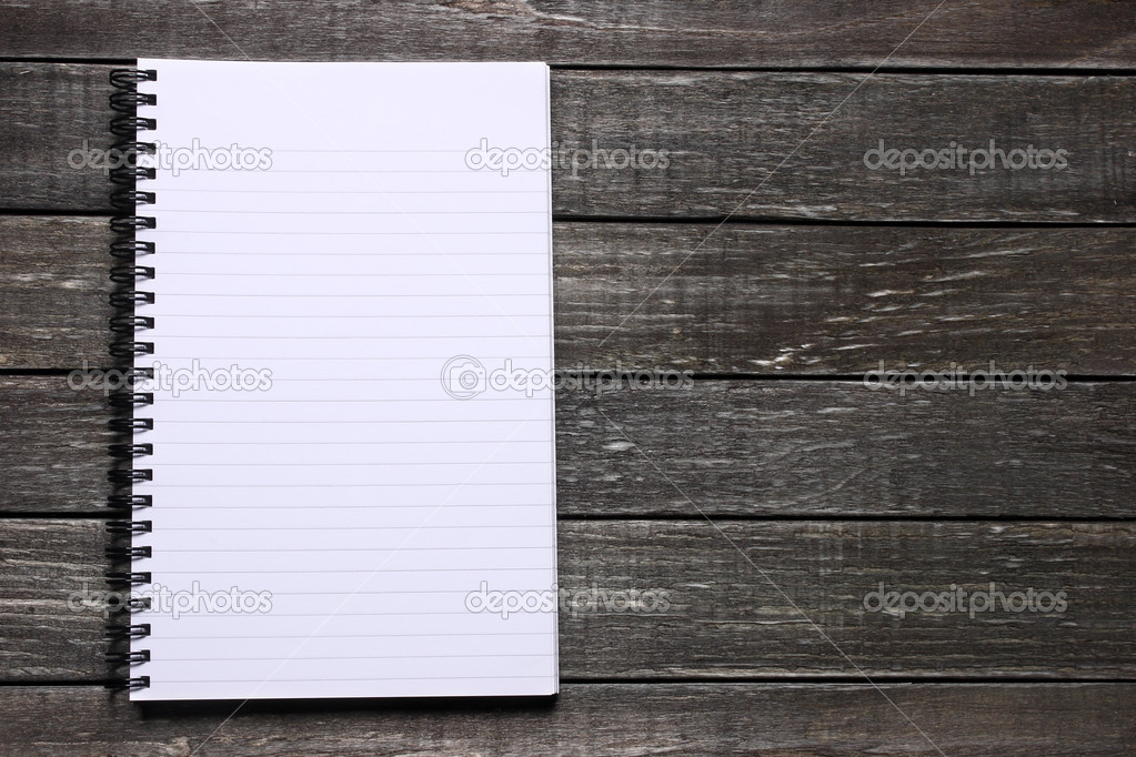 Open blank notepad on wooden table