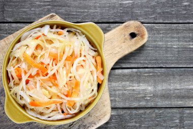 Sauerkraut with carrot in bowl clipart