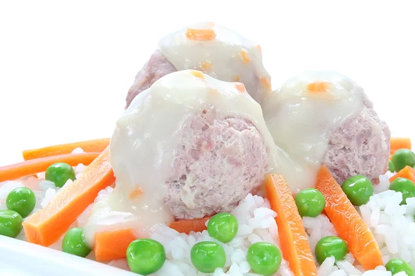 Pork meatballs with rice, carrots, peas and white sauce — Stock Photo, Image