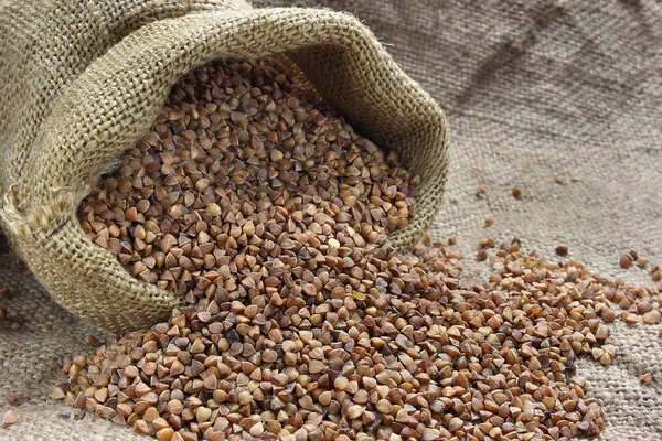 Raw buckwheat in canvas sack — Stock Photo, Image