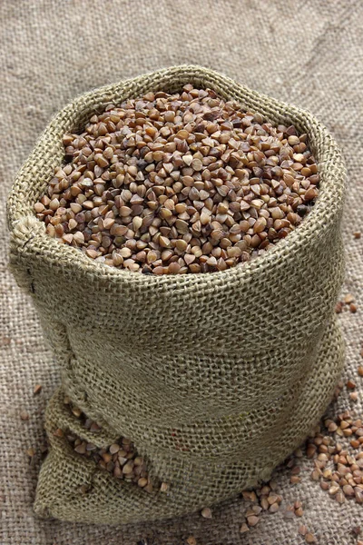 Raw buckwheat in canvas sack — Stock Photo, Image