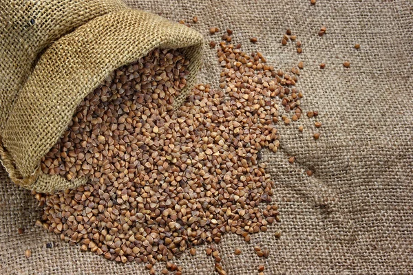 Raw buckwheat in canvas sack — Stock Photo, Image