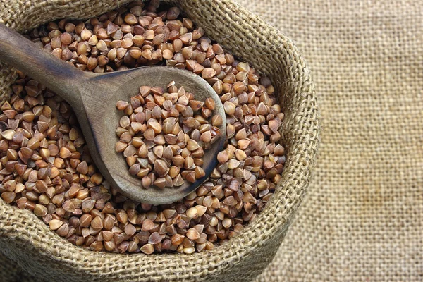 Raw buckwheat in canvas sack — Stock Photo, Image