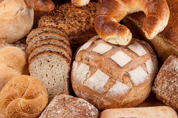 Group of different bread's type on wooden table — Stock Photo, Image