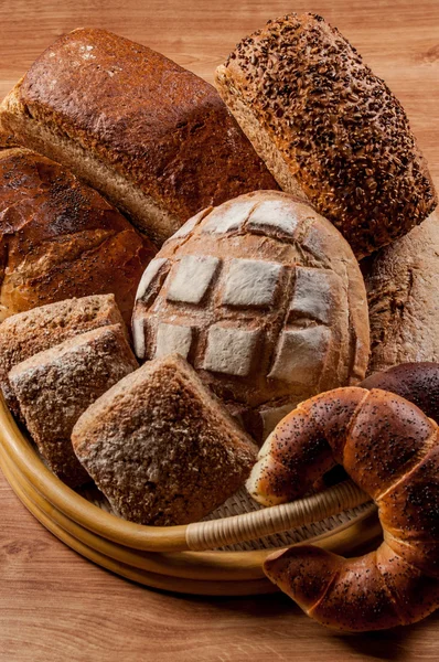 Group of different breads type on wooden table — Stock Photo, Image