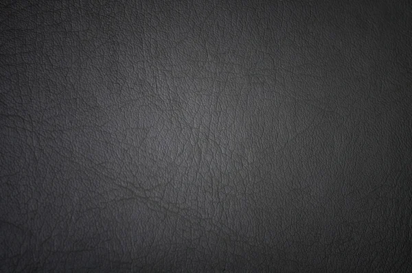 Dark grunge scratched leather to use as background — Stock Photo, Image