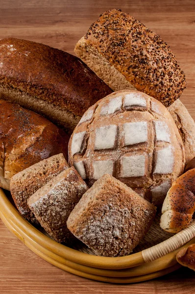 Group of different bread's type on wooden table — Stock Photo, Image