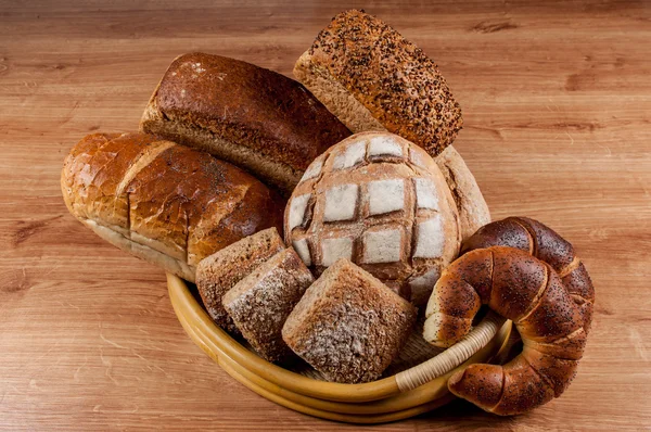 Group of different bread's type on wooden table — Stock Photo, Image