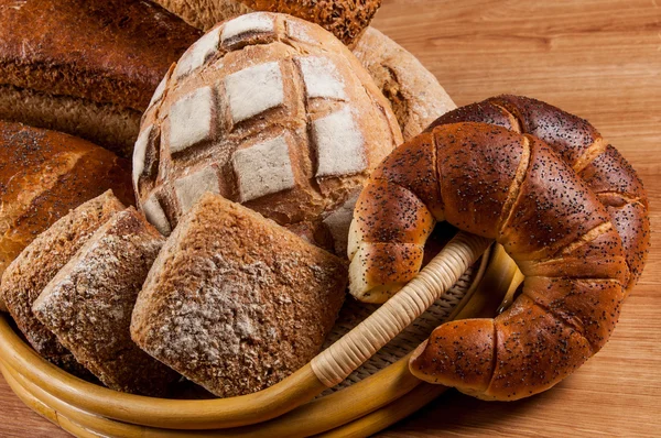 Group of different bread's type on wooden table — Stock Photo, Image