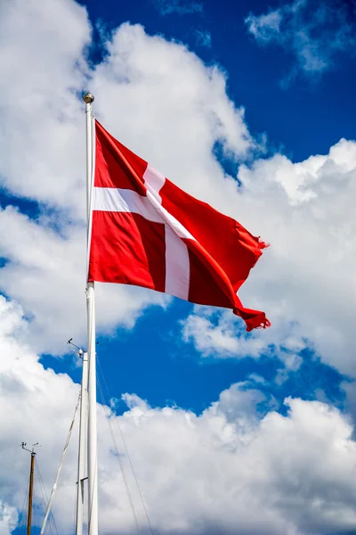 The danish flag and blue and cloudy sky — Stock Photo, Image