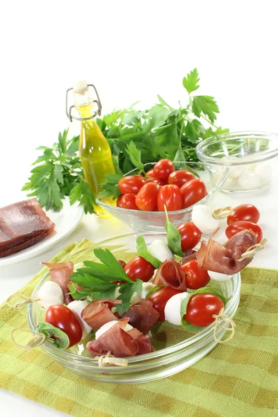 Fresh delicious Tomato, mozzarella and ham skewers — Stock Photo, Image