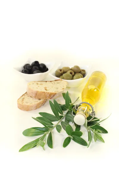 Bottle of olive oil with olives and branch — Stock Photo, Image