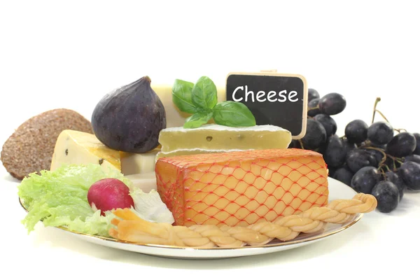 Pieces of cheese with blackboard — Stock Photo, Image